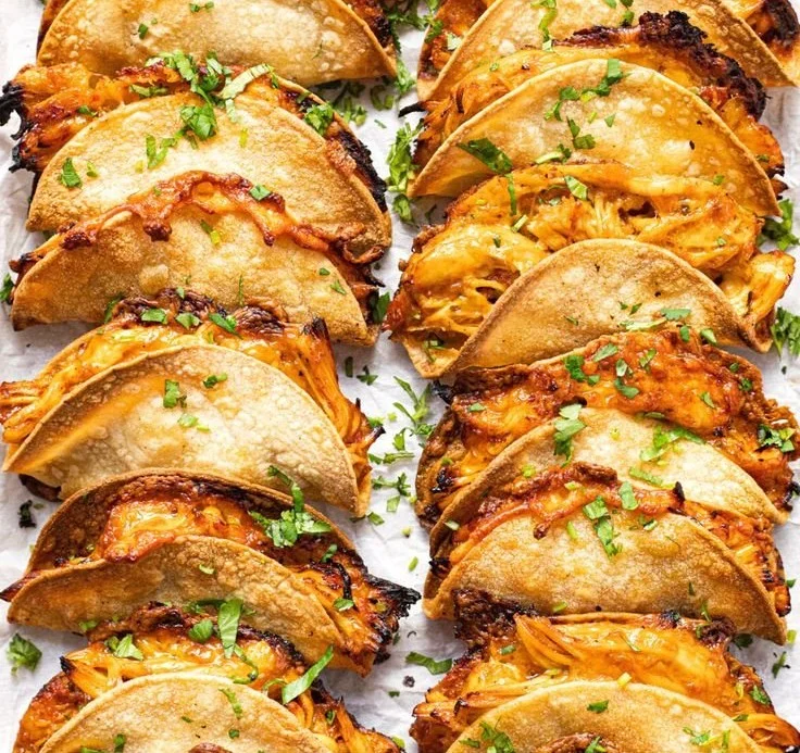 Mini baked chicken tacos served on a plate with toppings