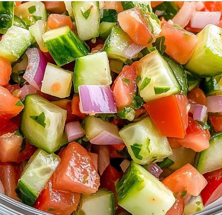 Bowl of refreshing Italian Cucumber Salad with tomatoes and herbs