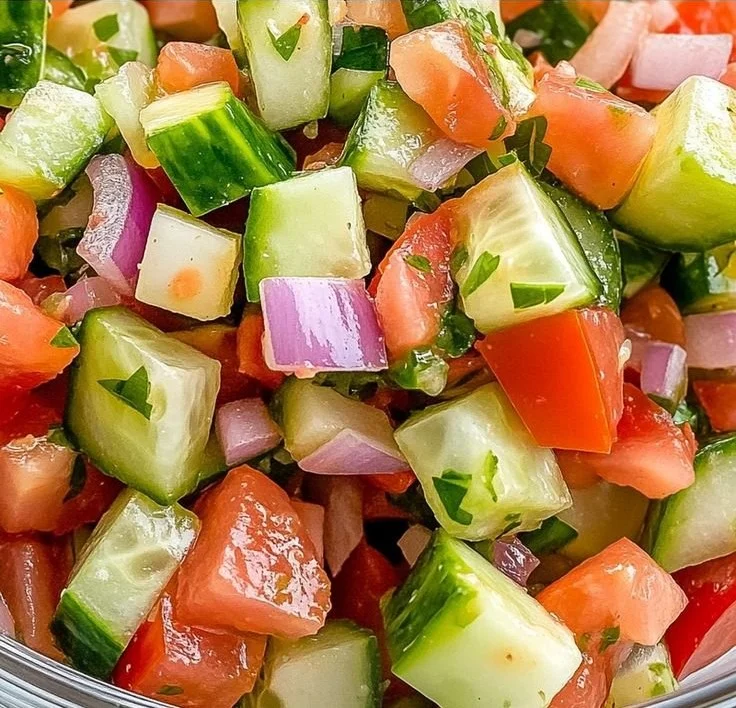 A colorful bowl of refreshing Italian Cucumber Salad with herbs and dressing.