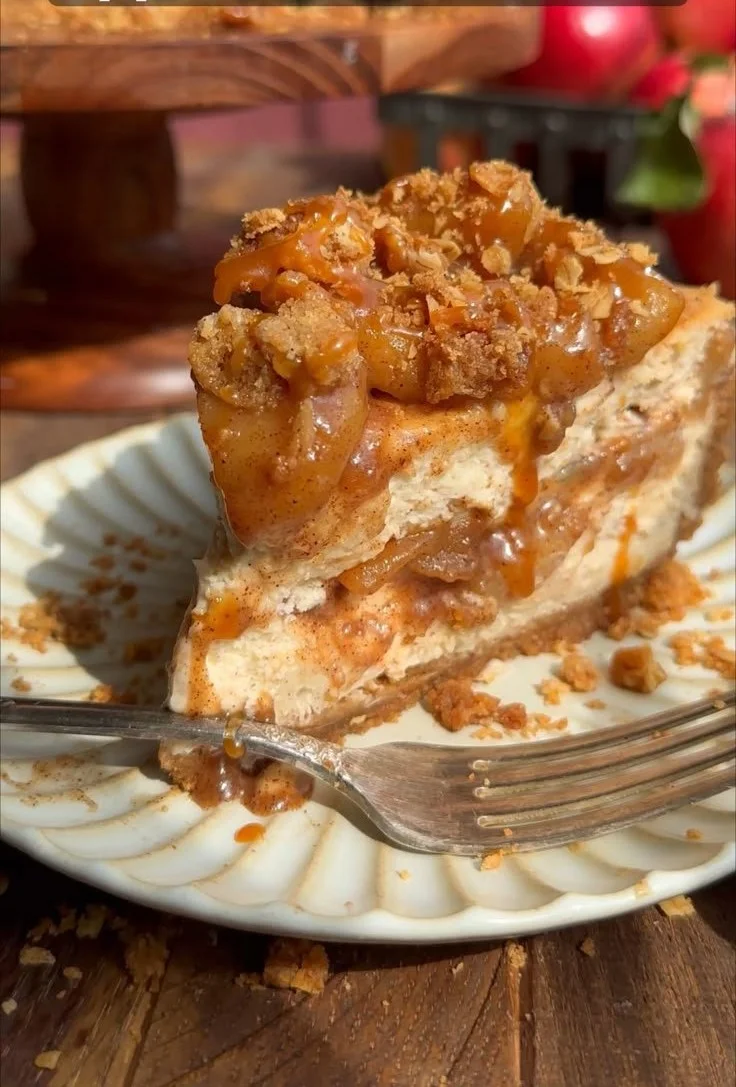 Delicious salted caramel apple pie cheesecake topped with caramel drizzle.