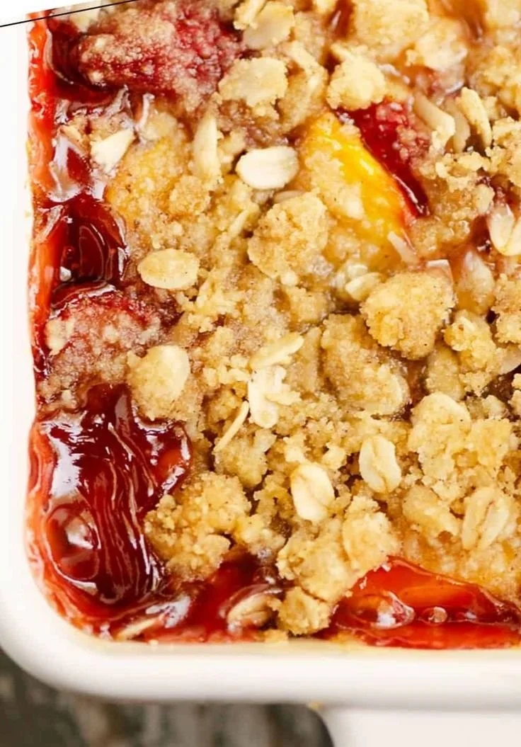 Freshly baked strawberry peach crisp topped with a crunchy oat topping.
