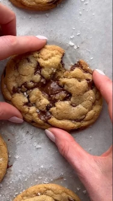 Freshly baked chocolate chip cookies on a cooling rack